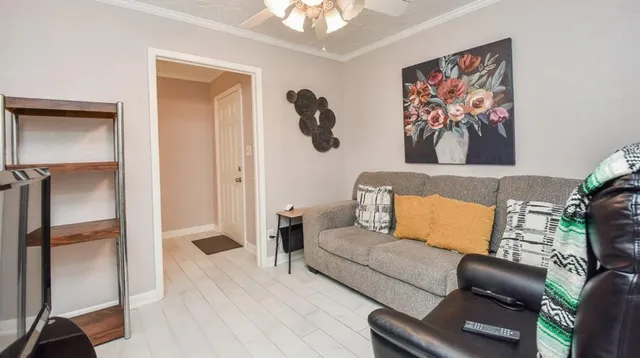 a living room with furniture and a flat screen tv