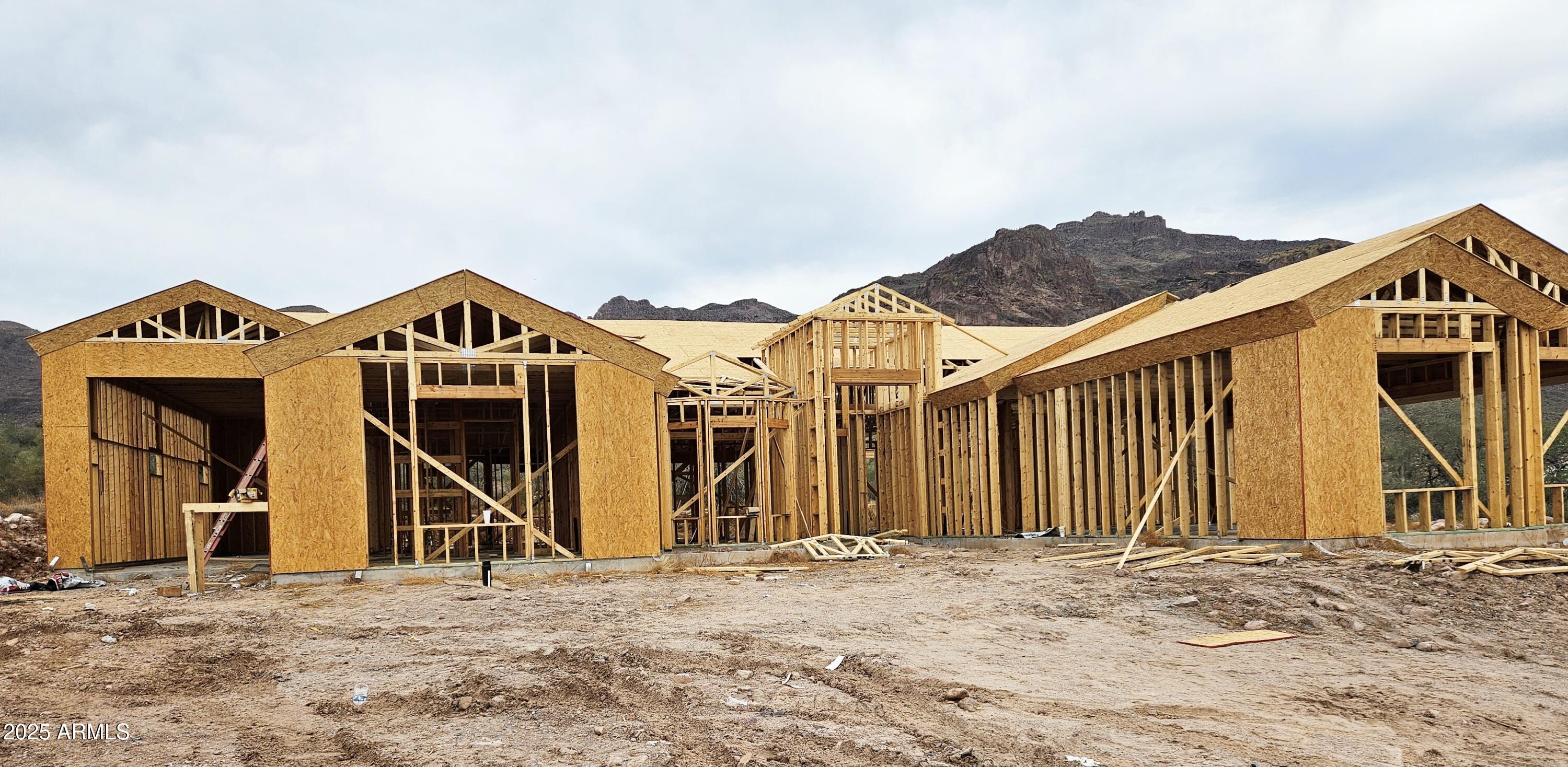 2669 South Southfork Ranch Road Gold Canyon, AZ 85118 - Photo 2 of 6 a view of a large house with large windows and wooden fence