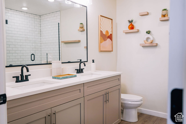 961 West Akoya Pearl Road, Unit 201 St. George, UT 84790 - Photo 22 of 67 Bathroom featuring double vanity, wood finished floors, an enclosed shower, and recessed lighting