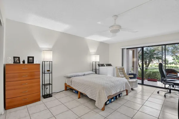 a bedroom with a bed and large windows