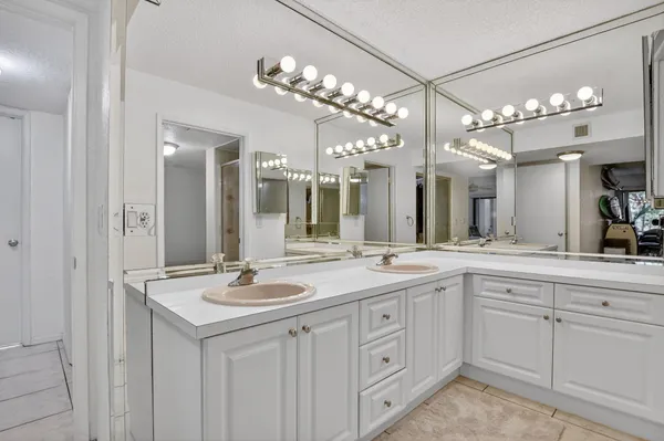 a spacious bathroom with a sink double vanity and a mirror
