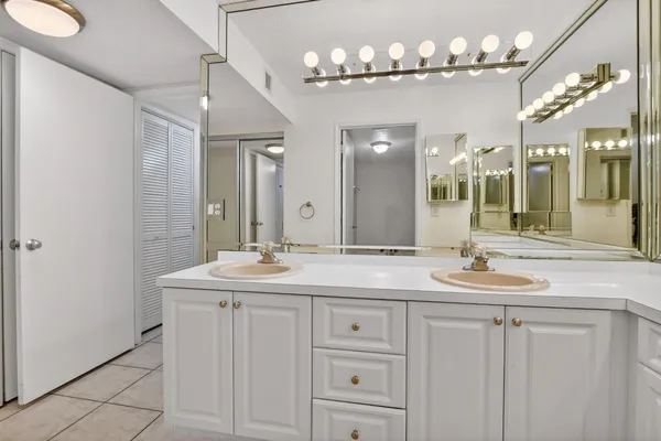 a bathroom with double sink and a mirror