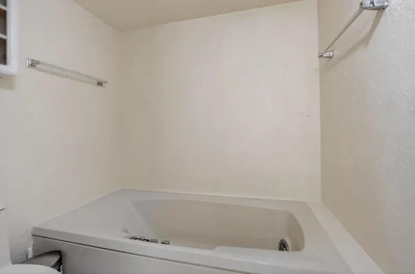 a white bath tub and shower