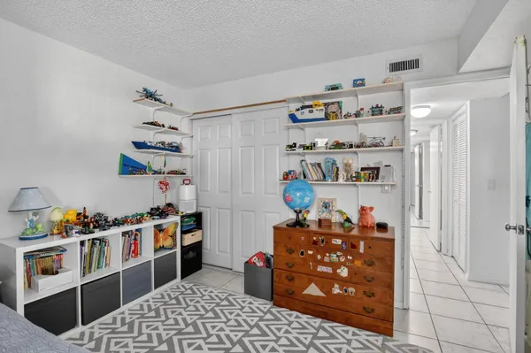 a storage room with lots of clutter and cabinets