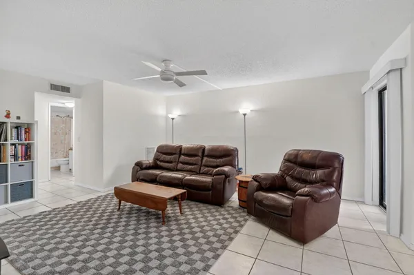 a living room with furniture and a rug