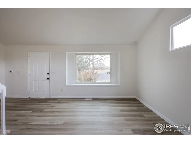 a view of an entryway with wooden floor