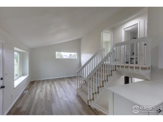 a kitchen with stainless steel appliances a sink wooden floor and cabinets