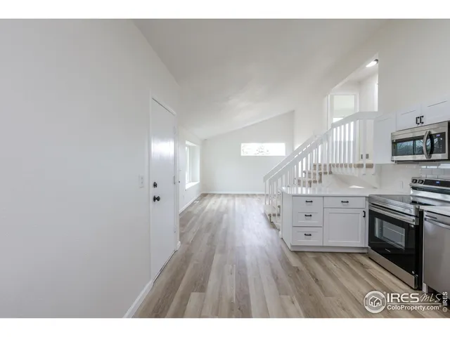 a view of kitchen with furniture and wooden floor