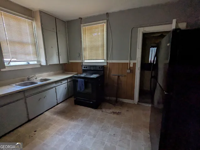 a kitchen with a sink and a refrigerator