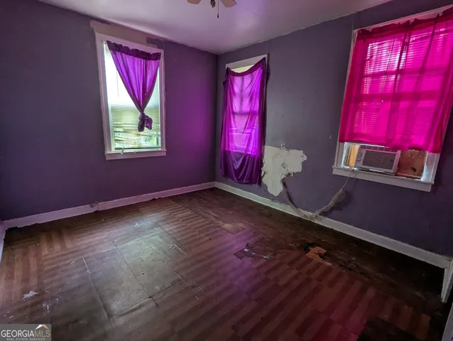 a view of room with hardwood floor and windows
