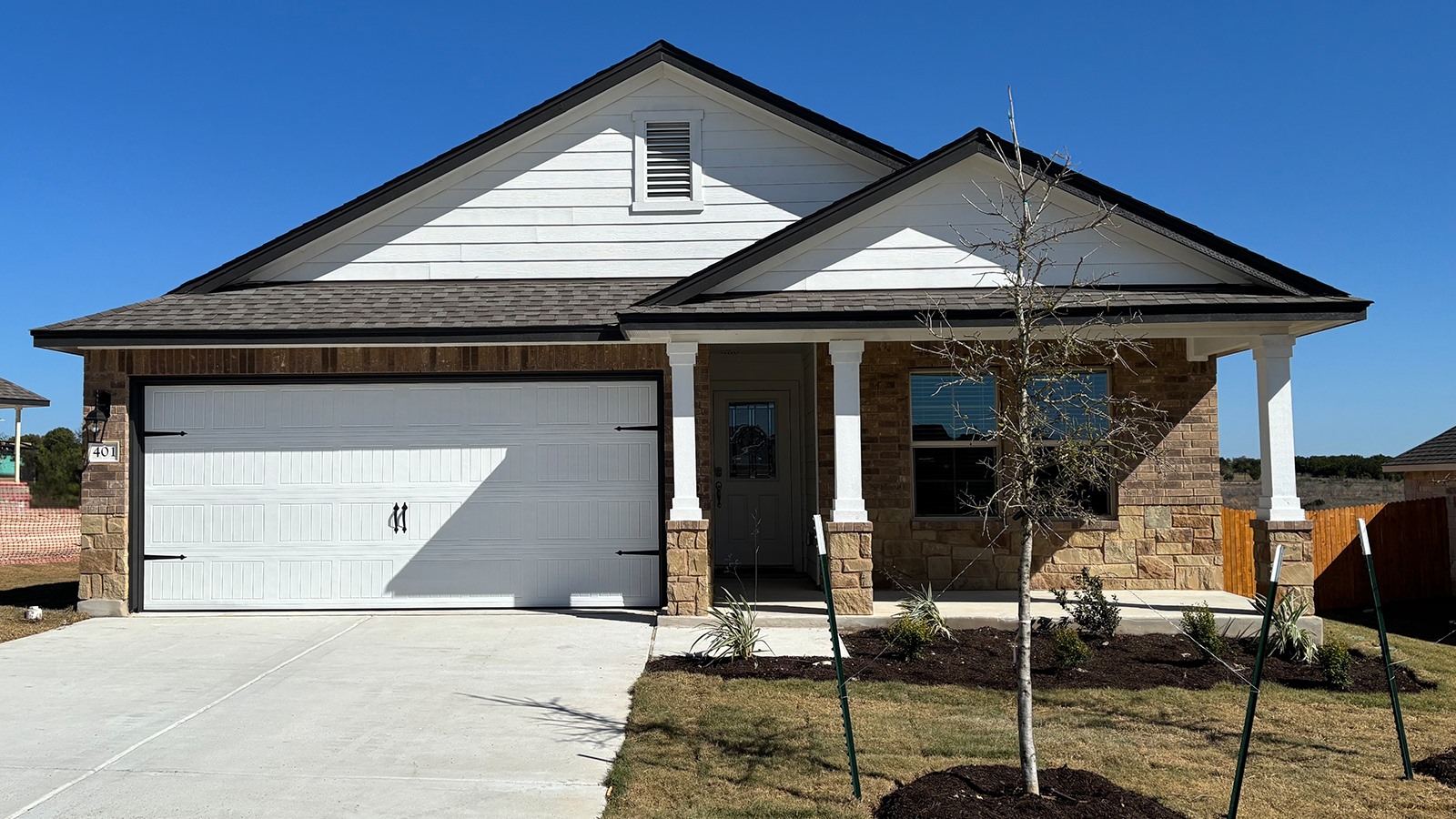 401 Creekfall Road Burnet, TX 78611 - Photo 1 of 23 a front view of a house with garage