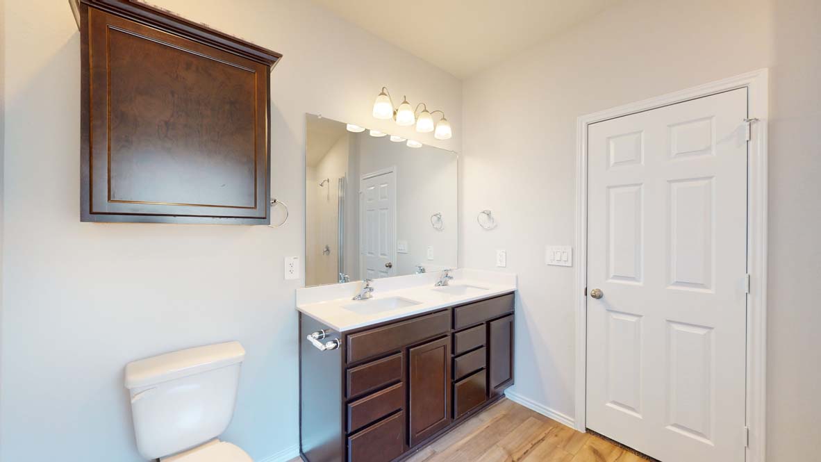 401 Creekfall Road Burnet, TX 78611 - Photo 12 of 23 a bathroom with a toilet a sink and mirror