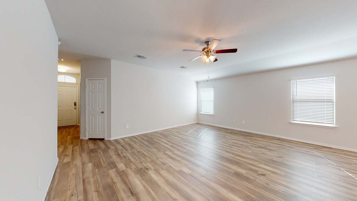 401 Creekfall Road Burnet, TX 78611 - Photo 2 of 23 wooden floor in an empty room with a window