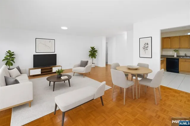 a living room with furniture a rug and a flat screen tv
