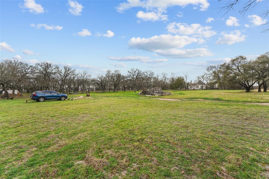 1051 Lynch Bend Road Springtown, TX 76082 - Photo 34 of 39 a view of yard with swimming pool and trees in the background