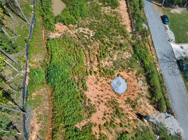 a aerial view of a house with table and chairs and wooden fence