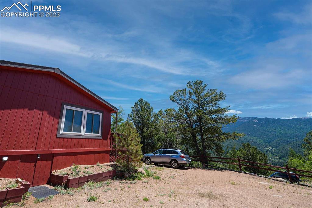 187 Blue Spruce Road Divide, CO 80814 - Photo 23 of 31 a backyard of a house with plants and trees