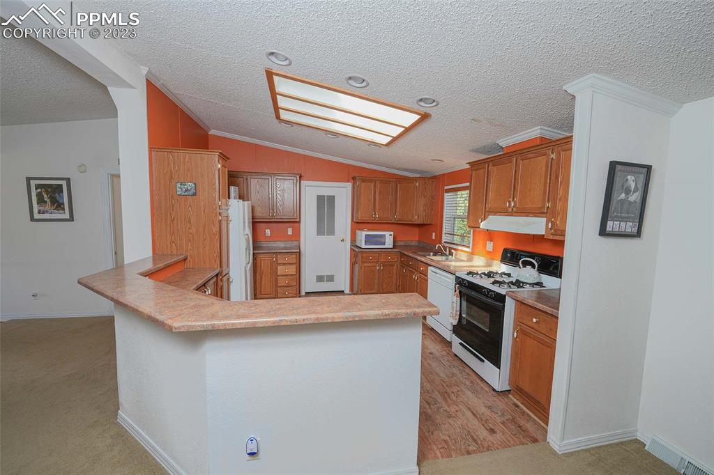187 Blue Spruce Road Divide, CO 80814 - Photo 5 of 31 a kitchen with stainless steel appliances granite countertop a stove and a refrigerator