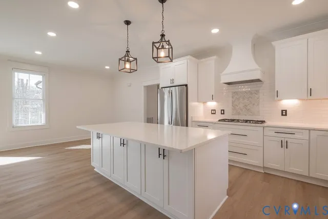a kitchen with white cabinets and white appliances