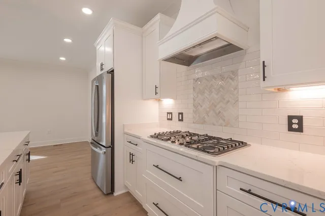 a kitchen with cabinets and a stove top oven