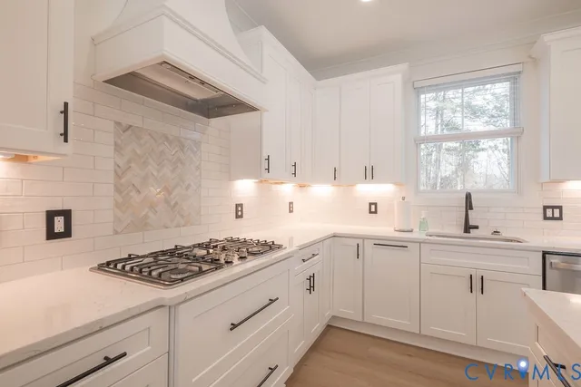 a kitchen with white cabinets and appliances