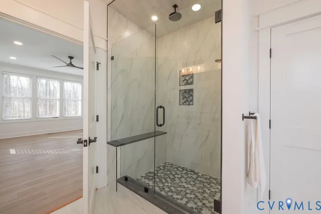 a bathroom with a glass shower door