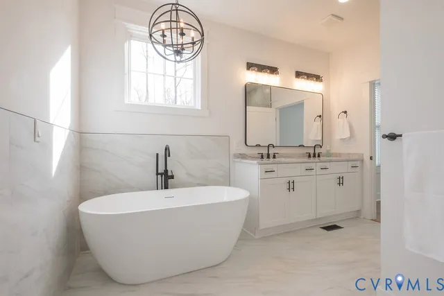 a bathroom with a bathtub a sink and a window