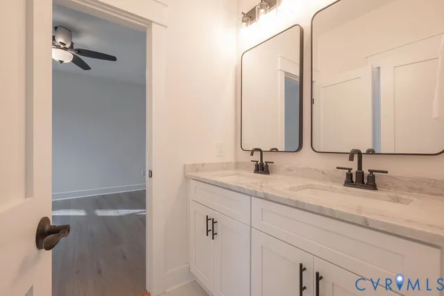 a bathroom with a double vanity sink and a mirror