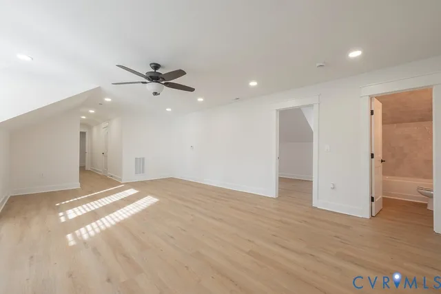 a view of an empty room and wooden floor