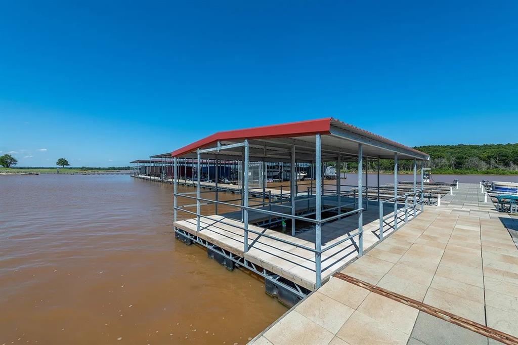 60 Timber Bank Drive Gordonville, TX 76245 - Photo 19 of 24 a view of a roof deck with couches and wooden floor
