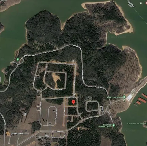 a view of a white house with a street