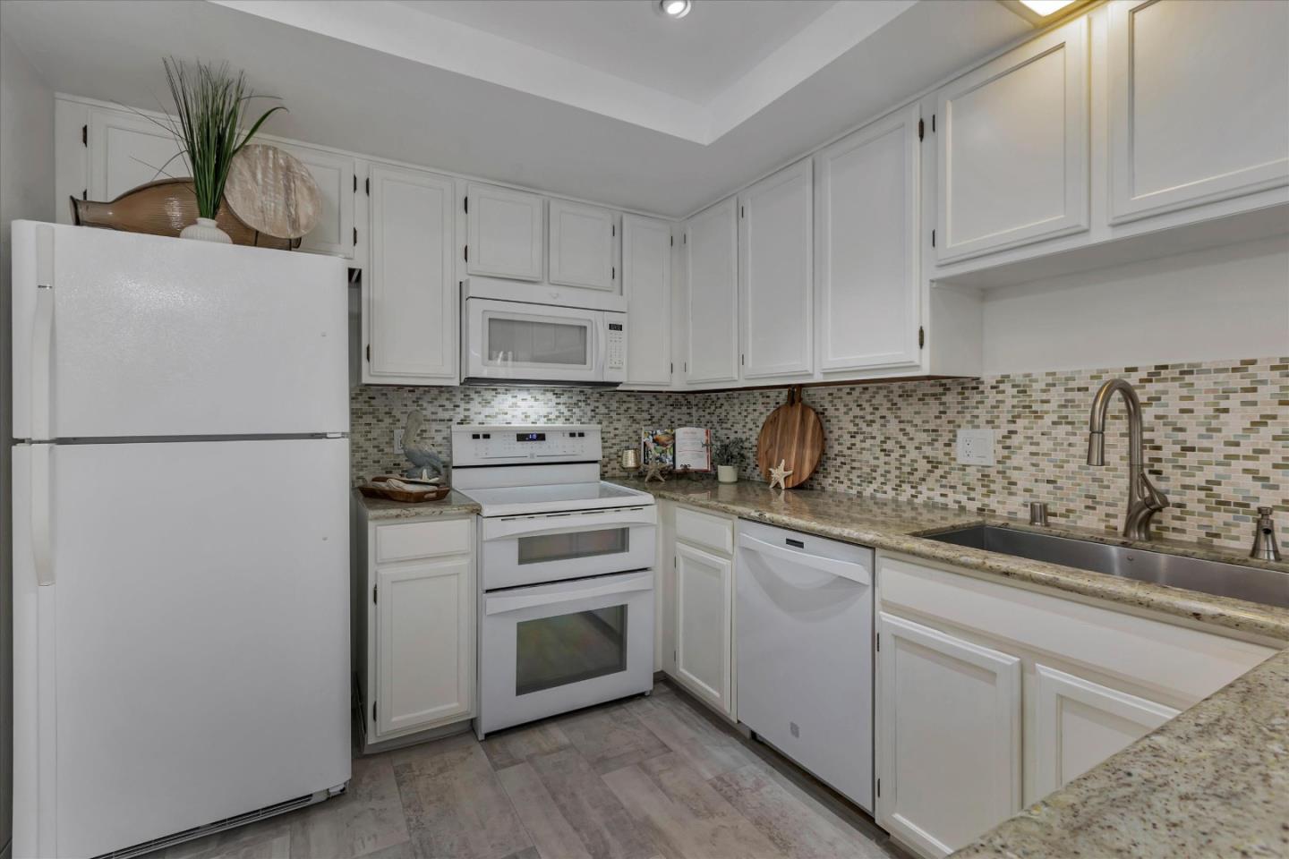 38 Devonshire Avenue, Unit 2 Mountain View, CA 94043 - Photo 11 of 38 a kitchen with white cabinets and white appliances