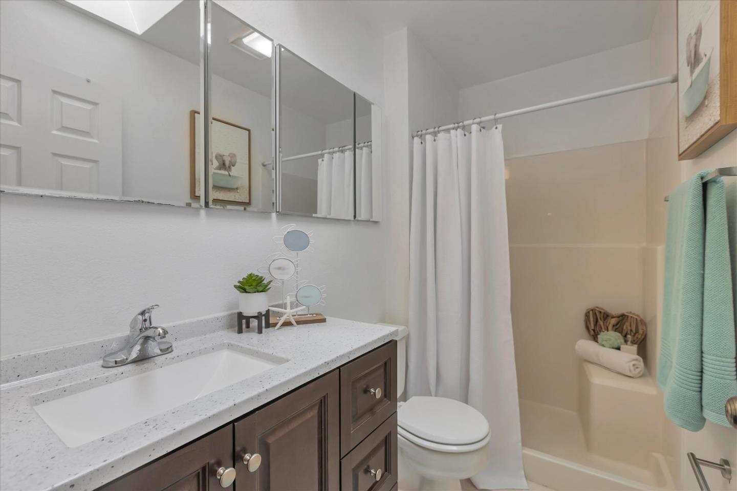 38 Devonshire Avenue, Unit 2 Mountain View, CA 94043 - Photo 18 of 38 a bathroom with a granite countertop sink a toilet and a mirror