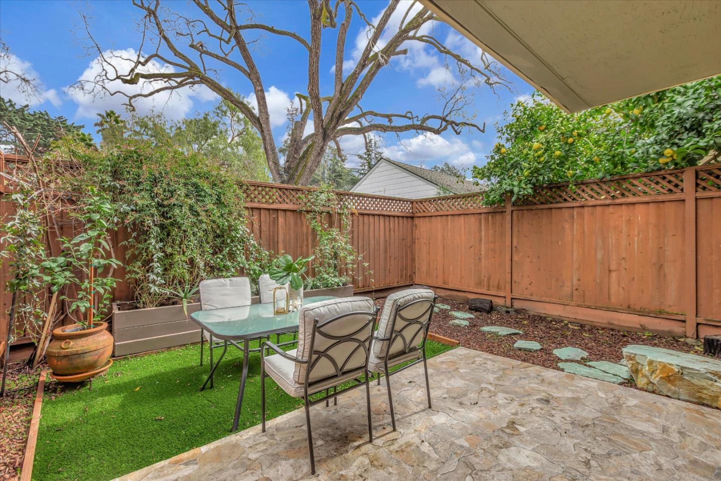 38 Devonshire Avenue, Unit 2 Mountain View, CA 94043 - Photo 28 of 38 a view of a chairs and table in backyard of the house