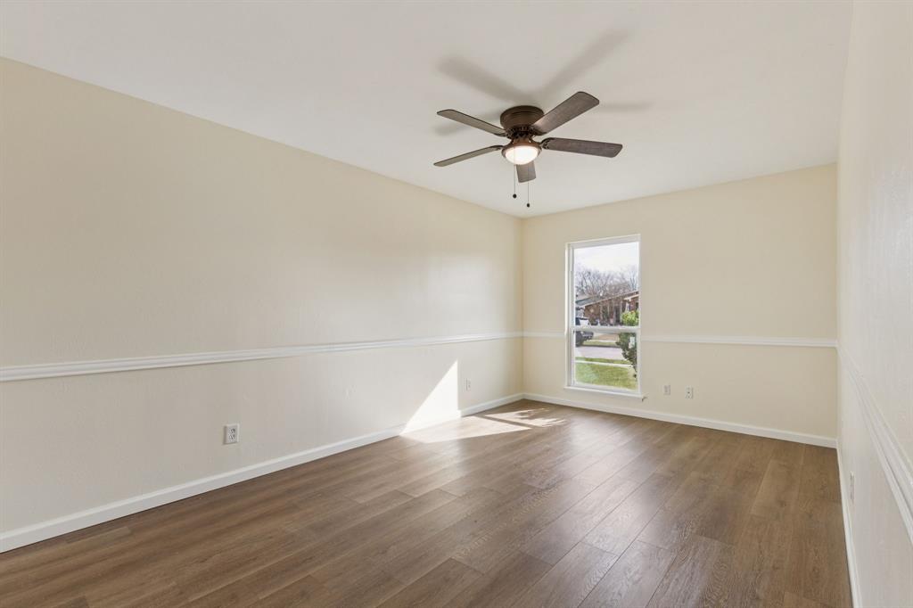 9305 Pollard Street Rowlett, TX 75088 - Photo 15 of 30 an empty room with wooden floor fan and windows