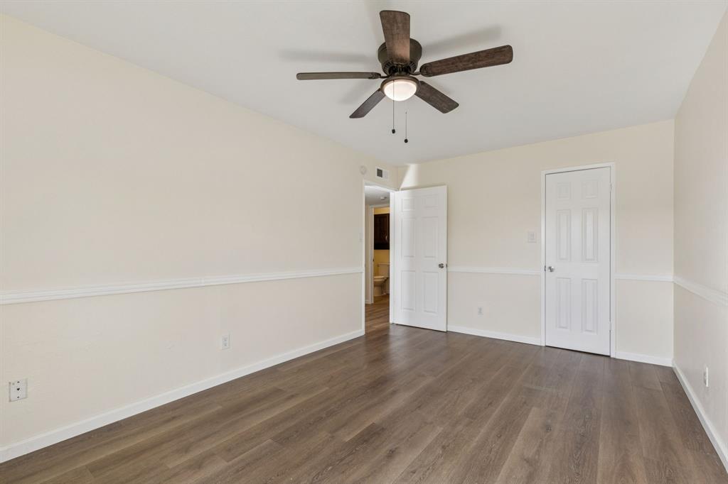 9305 Pollard Street Rowlett, TX 75088 - Photo 16 of 30 an empty room with wooden floor ceiling fan and window