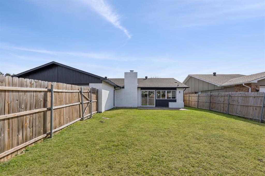9305 Pollard Street Rowlett, TX 75088 - Photo 25 of 30 a view of a house with a yard and a large window