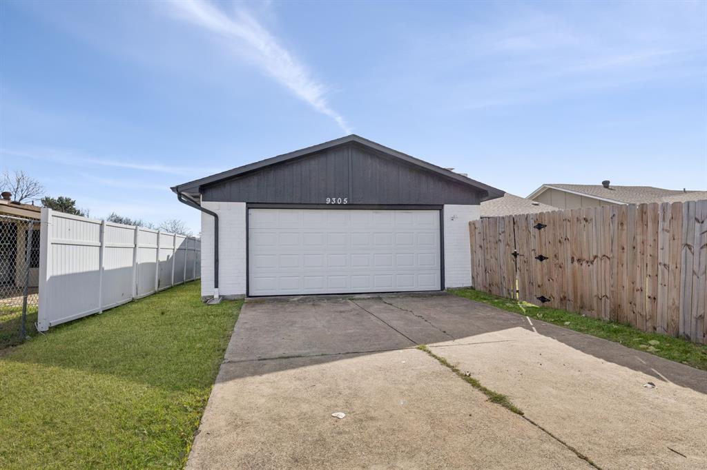9305 Pollard Street Rowlett, TX 75088 - Photo 26 of 30 a front view of a house with a yard and garage