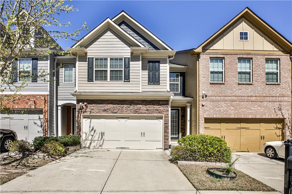 a front view of a house with a yard and garage