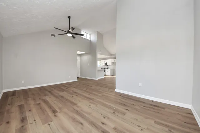 wooden floor in an empty room with a window