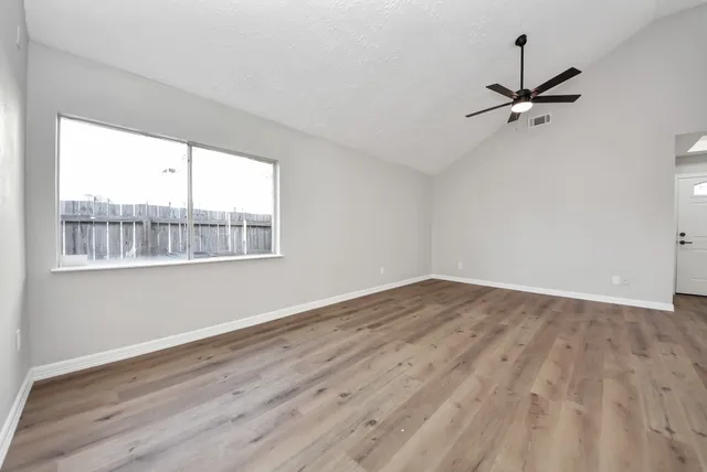 a view of a kitchen with a sink and dishwasher a refrigerator with wooden floor