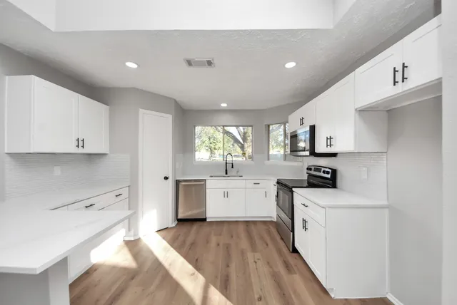 a view of a kitchen cabinets and a center island with wooden floor