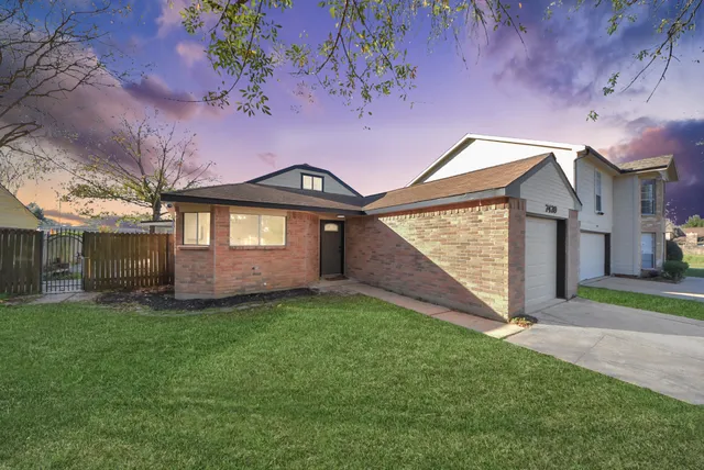 a front view of a house with garden