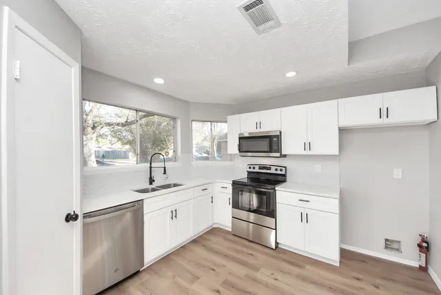 a bathroom with a sink a toilet and a bathtub
