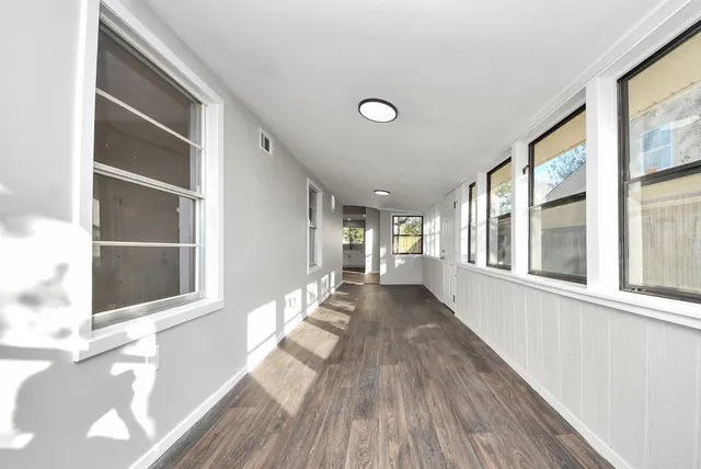 wooden floor in an empty room with a window
