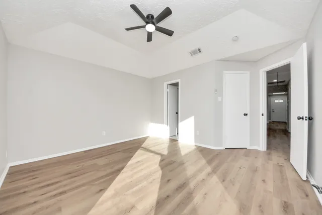 a bathroom with a sink vanity granite tub and a mirror