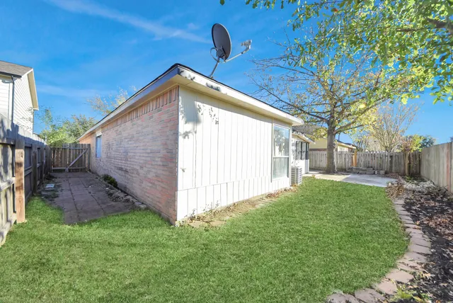 a view of a backyard with wooden fence