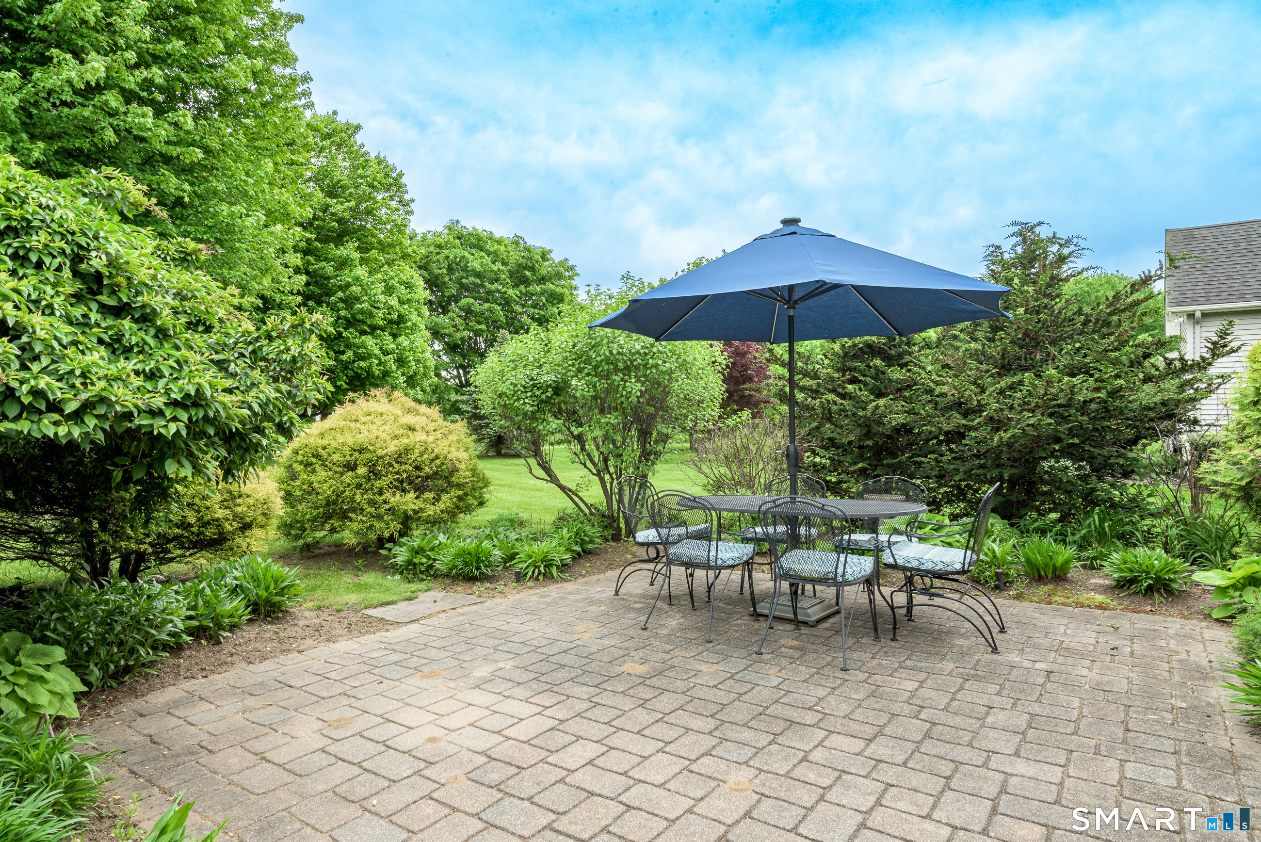 8 Greendale Drive, Unit 8 Suffield, CT 06078 - Photo 15 of 40 a lawn chair sitting under a blue umbrella