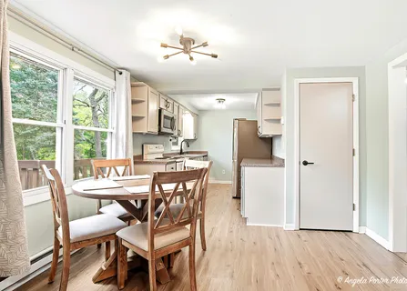 a view of a dining room with furniture and wooden floor