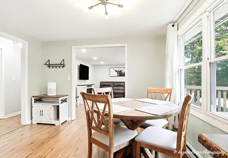 a living room with furniture and wooden floor